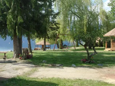 a park with a swing and trees and a playground at Jewel Bay Resort in Sorrento