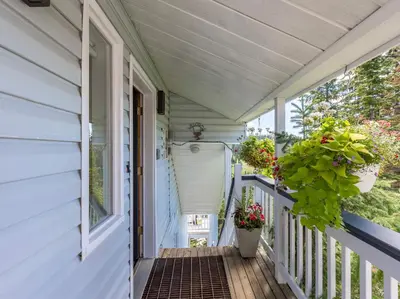 a porch with a door and a plant at The Alpine I No Service Fee's I Ski-in Ski-Out I in Silver Star