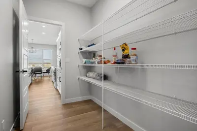 a hallway with white shelves in a room at Bright & Spacious 3 Beds Luxury Home in SE Calgary in Calgary