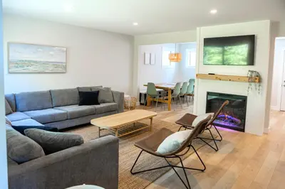 a living room with a couch and a fireplace at Surfs Inn Guesthouse & Cottages in Ucluelet