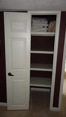 a closet with a white door in a room at Window Hill in St. Albert
