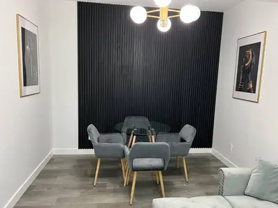 a dining room with a glass table and chairs at Modern Luxury Private Suite in Airdrie