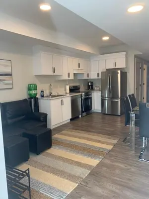 a living room with a couch and a kitchen at Entire 2BR Guest House in Quiet Area in Nanaimo