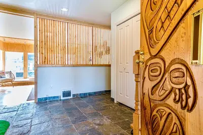 a room with a wooden door in a room at Three-Tree Villa-Central Location in Vancouver
