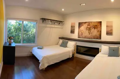 a bedroom with two beds and a window at Westside Pool Home-8 min to Downtown, Yard Parking in Vancouver