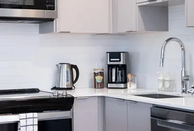 a kitchen with white cabinets and a counter top at RevelStoked Getaway by Revelstoke Vacations in Revelstoke