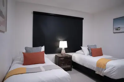 two beds in a room with a black wall at RevelStoked Getaway by Revelstoke Vacations in Revelstoke