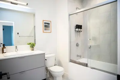 a bathroom with a shower and a toilet and a sink at Revy Mountain Retreat in Revelstoke