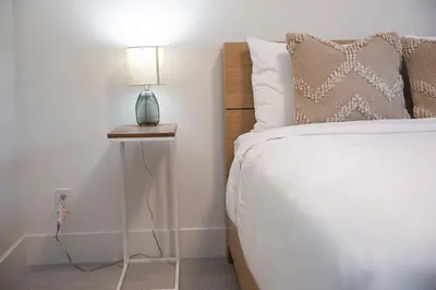 a bedroom with a bed and a lamp on a side table at Revy Mountain Retreat in Revelstoke