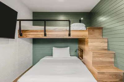 a small room with two bunk beds in it at Hotel Canoe and Suites in Banff