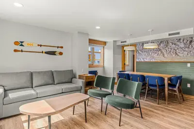 a living room with a couch and chairs and a table at Hotel Canoe and Suites in Banff