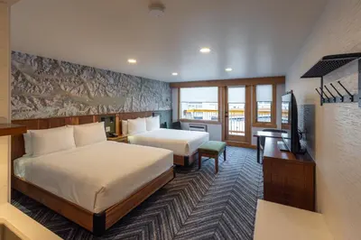 a hotel room with two beds and a television at Hotel Canoe and Suites in Banff