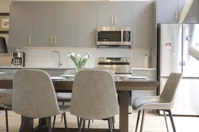 a kitchen with a table with chairs and a refrigerator at Immersed in the scenery of Canmore in Canmore
