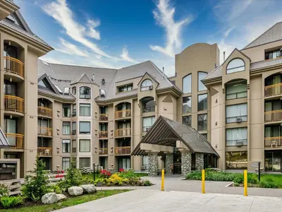 a large apartment complex with a large building at Ski In/Out, Steam Shower, Pool, Hot Tub, Sauna in Whistler