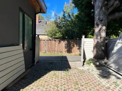 a door to a house with a tree next to it at Brand New Modern Laneway House in Vancouver