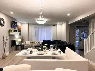 a living room with a couch and a table at Flowealth Property Luxury Villa Near Lake Netflix TV Wifi in Calgary