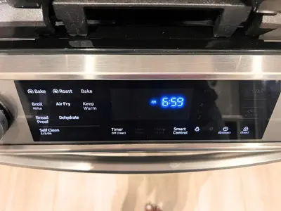 a close up of a microwave with a clock on it at Flowealth Property Luxury Villa Near Lake Netflix TV Wifi in Calgary