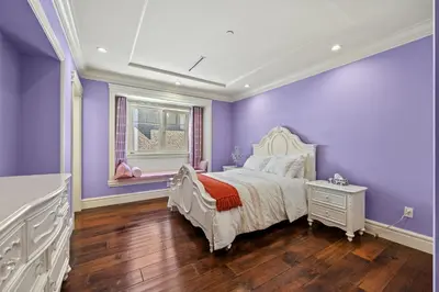 a purple bedroom with a white bed and a window at Spacious Cozy House in Vancouver West in Vancouver