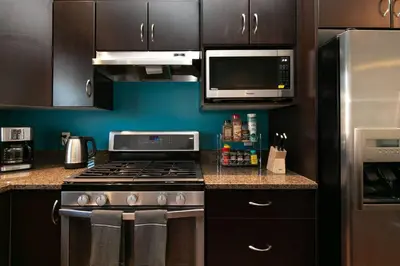 a kitchen with a stove and a microwave at Entire 3-bedroom house Near Town in Victoria
