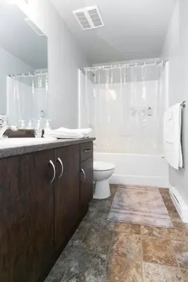a white bathroom with a toilet and a sink at Entire 3-bedroom house Near Town in Victoria