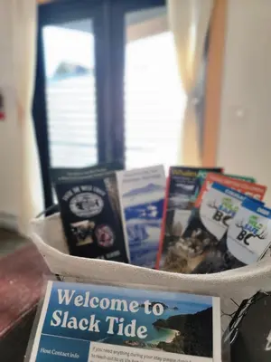 a basket full of books sitting on a table at Slack tide suite in Ucluelet