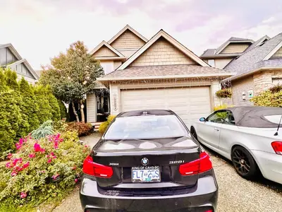 two cars parked in front of a house at Scorpio House Langley- ROOM 3 in Langley