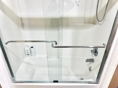 a shower with a glass door and a sink at Scorpio House Langley- ROOM 3 in Langley