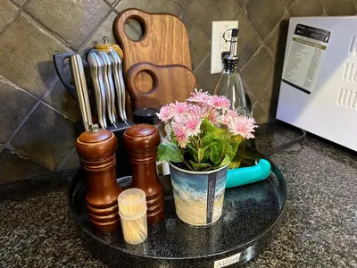 a table with a vase with flowers and a guitar at Scorpio House Langley- ROOM 3 in Langley