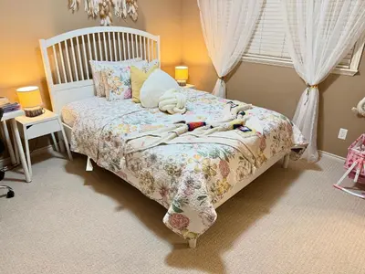 a bedroom with a bed with dolls laying on it at Scorpio House Langley- ROOM 3 in Langley