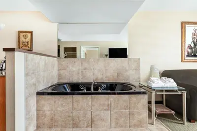 a kitchen with a sink in a room at Ramada by Wyndham Clairmont/Grande Prairie in Clairmont