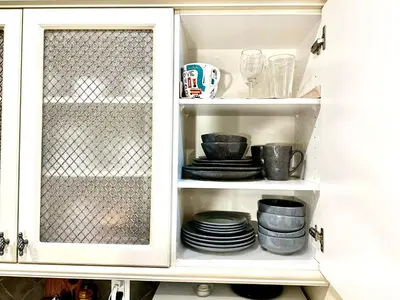 a cabinet filled with plates and cups and dishes at Scorpio House Langley -ROOM 2 in Langley