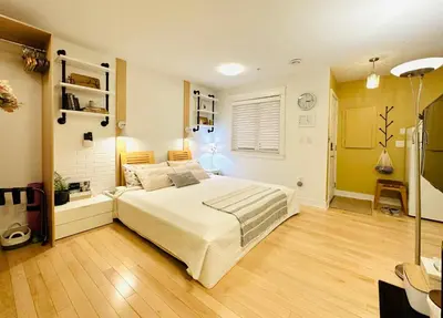 a bedroom with a bed and a lamp in it at Private Guest Suite 10mins to Downtown - King Bed - Bathtub - Free Parking in Vancouver