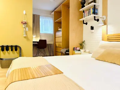 a bedroom with a white bed and a yellow wall at Private Guest Suite 10mins to Downtown - King Bed - Bathtub - Free Parking in Vancouver