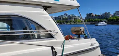 a white boat with a box on the side of the water at GYPSIES DRIFTER in Vancouver