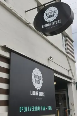 a sign on the front of a liquor store at Hotel at the Waldorf in Vancouver