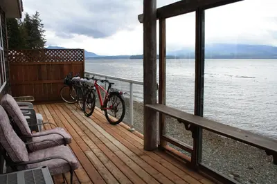 two bikes parked on a deck next to the water at Orca Lodge in Sointula
