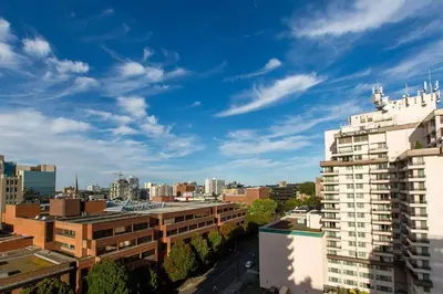 a view of a city with buildings and a blue sky at Waterfalls Hotel in Downtown With Stunning Views! in Victoria