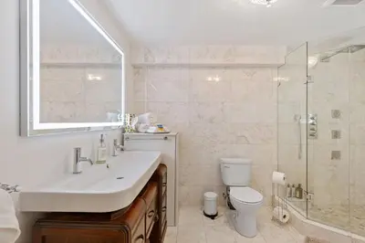 a bathroom with a sink and a toilet and a shower at Carrington Chateau in Vancouver