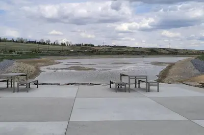 three benches sitting in front of a body of water at Brand New Executive Suite in Calgary