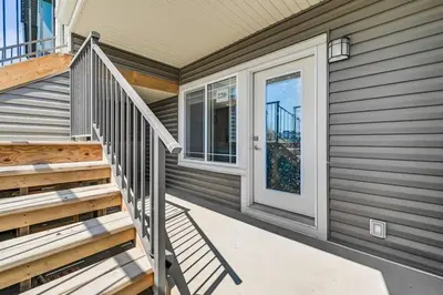 a home with a staircase leading to the front door at Brand New Executive Suite in Calgary
