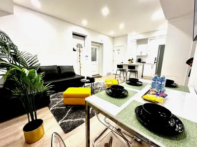 a kitchen and living room with a table in a room at Sparsh Villas - Luxurious & Stylish 2BR PSuite in Langley