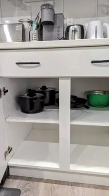 a kitchen shelf with pots and pans on it at Cozy basement for a lovely stay & perfect for WFH in Edmonton