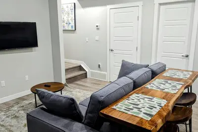 a living room with a couch and a table at Cozy basement for a lovely stay & perfect for WFH in Edmonton
