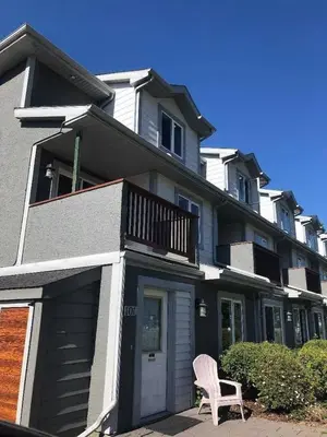 a house with a chair in front of it at Mountain view walk to all in Canmore Canada in Canmore