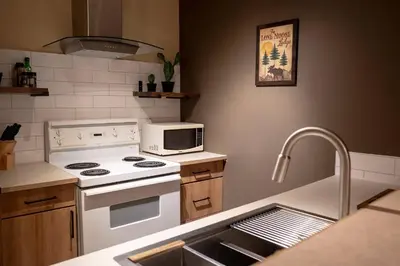 a kitchen with a white stove and a sink at Mountain view walk to all in Canmore Canada in Canmore