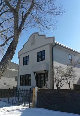 a white building with a tree in front of it at Brand New 1 Br 1 Bath Close To All Walkable in Edmonton