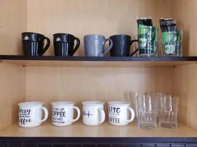 a row of coffee mugs sitting on a shelf at Si & Daniel Home Near YVR Airport & Skytrain Separate Entry Free Parking in Richmond