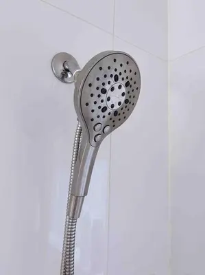 a shower with a shower head in a bathroom at Si & Daniel Home Near YVR Airport & Skytrain Separate Entry Free Parking in Richmond