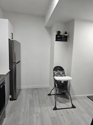 a kitchen with a table and a chair in a room at New built house, Stay in Style Guest Suite, 2bedroom, 2bed, 2bath in Edmonton