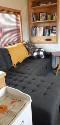 a couch with a blanket on it in a living room at Peace and Quiet in Lac La Biche